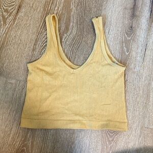 Out from under yellow tank top